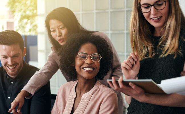 Smiling group of diverse businesspeople working in an office