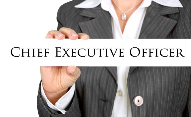 a businesswoman holding a title with the words "Chief Executive Officer"