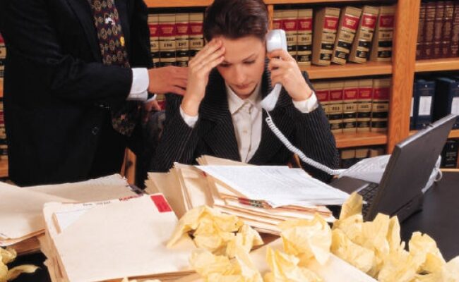 a busy executive at their desk while on the phone