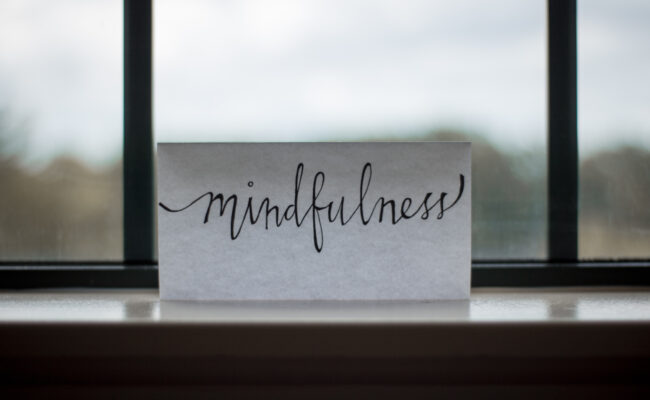 a note on a windowsill that says "mindfulness" in handwriting