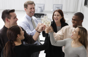 five coworkers toasting after Champagne