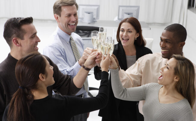 five coworkers toasting after Champagne